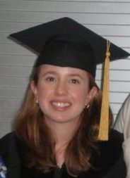 This is a photo of Lori in a black graduation cap with a yellow tassel. She is 28 years old, has long brown hair, and her eyeballs could handle contact lenses back then.